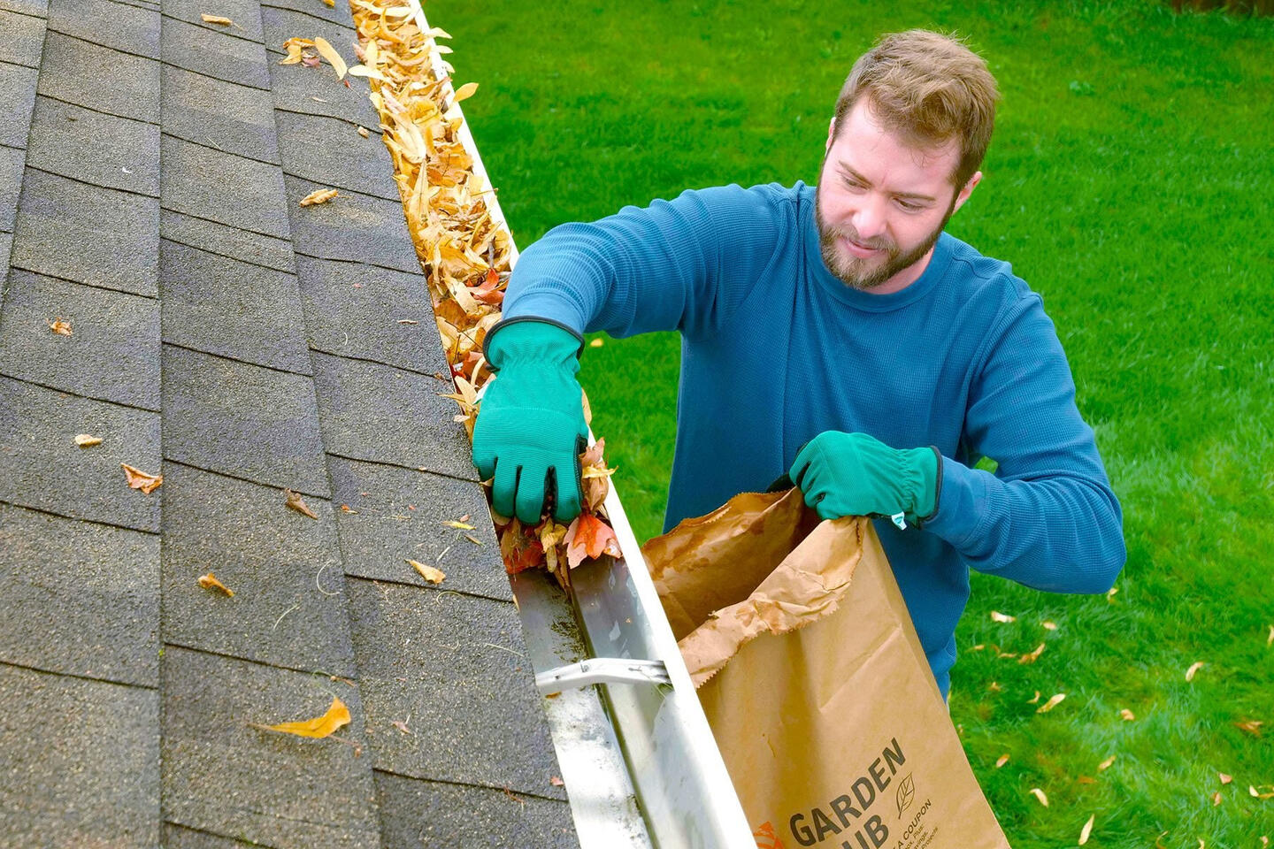 man cleaning gutters